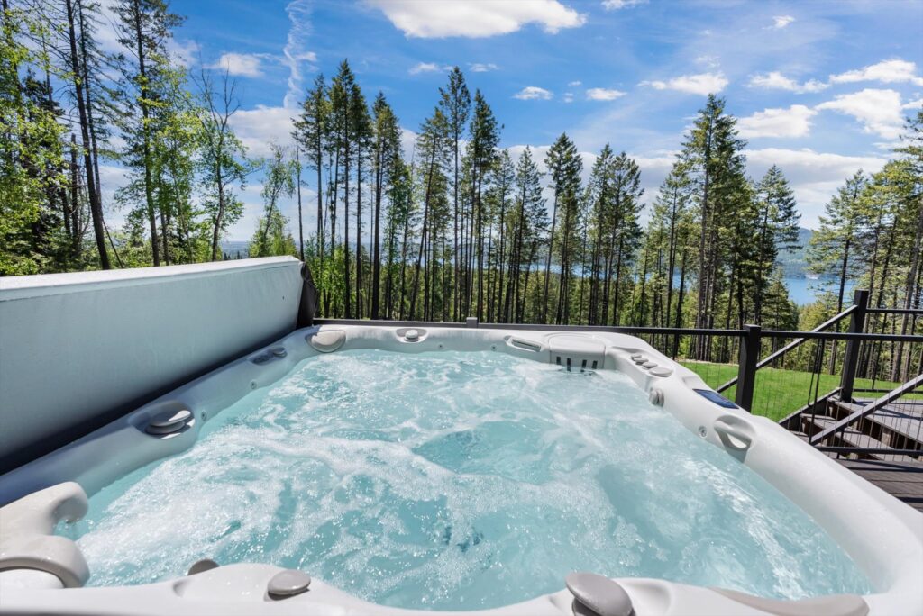 Large capacity hot tub with lake views at Great Northern Mountain Escape