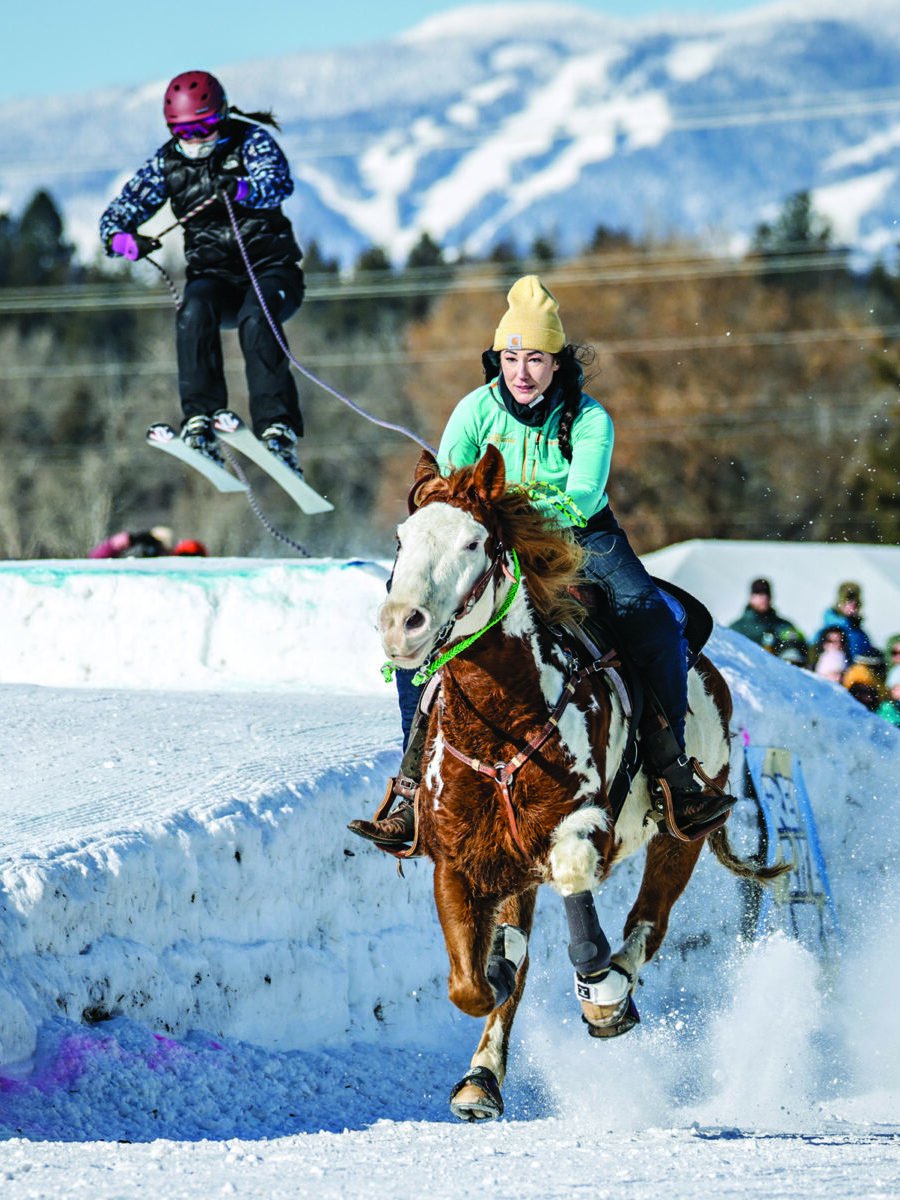 Whitefish Montana Winter Carnival skijoring event with skier flying through the air being towed behind a galloping horse.